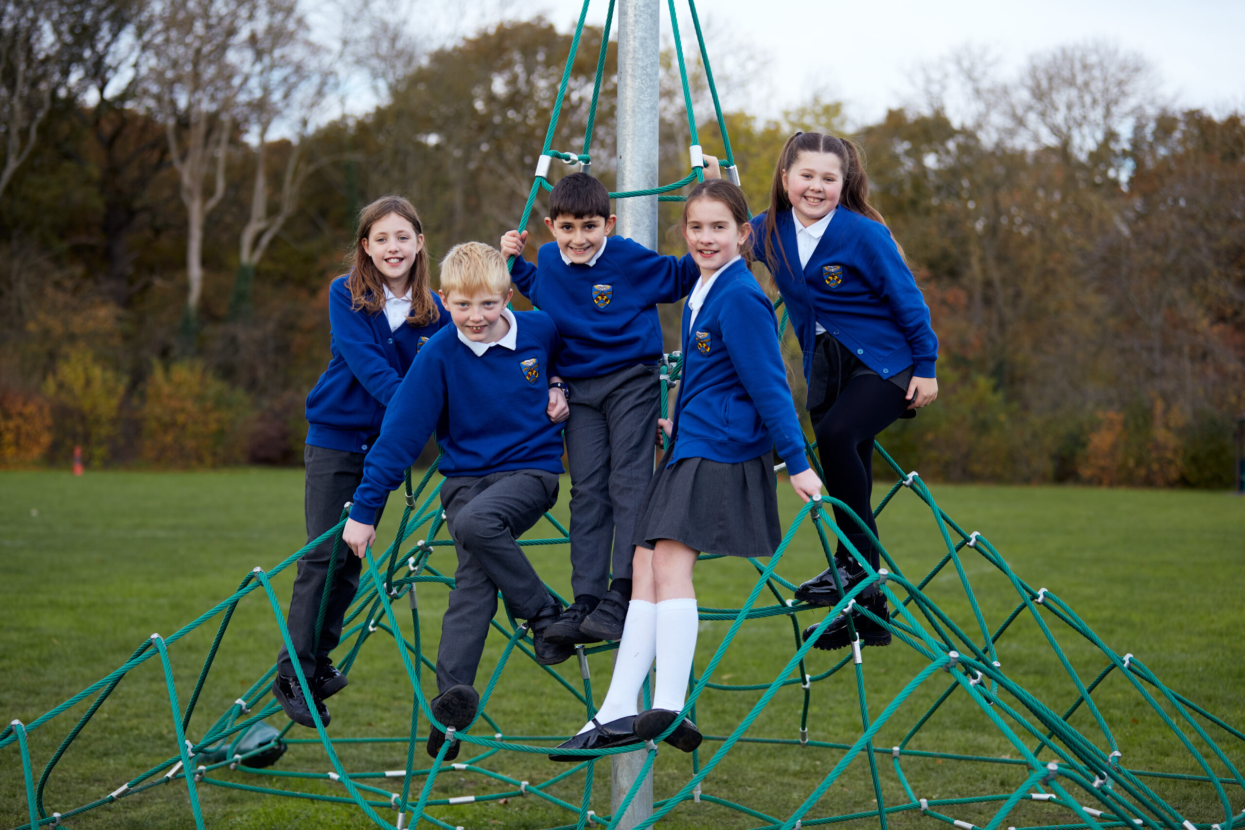 Students playing on outdoor equipment
