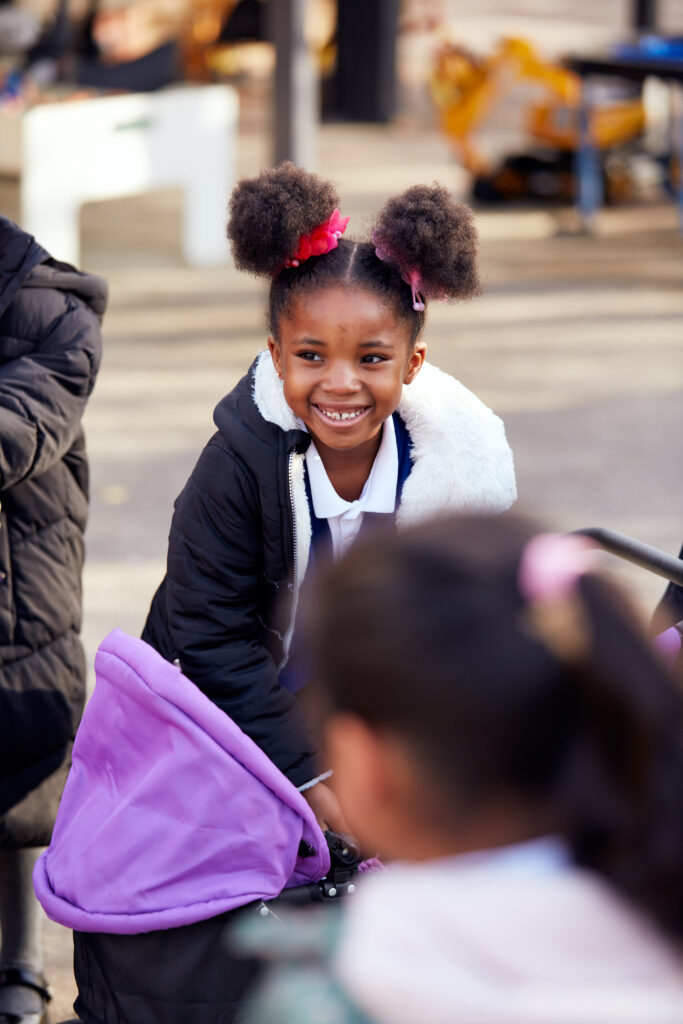 Student smiling at the camera outside