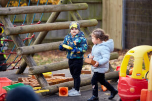 Nursery student playing with outdoor equipment